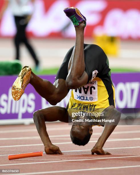 Usain Bolt of Jamaica falls to the track in the Men's 4x100 Relay final during day nine of the 16th IAAF World Athletics Championships London 2017 at...