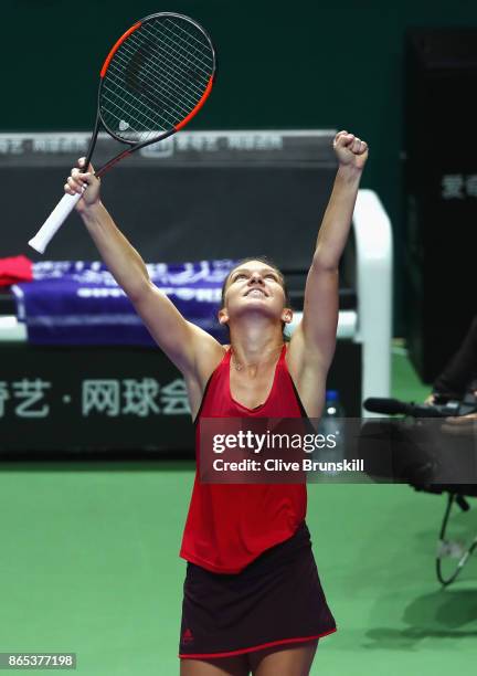 Simona Halep of Romania celebrates victory in her singles match against Caroline Garcia of France during day 2 of the BNP Paribas WTA Finals...