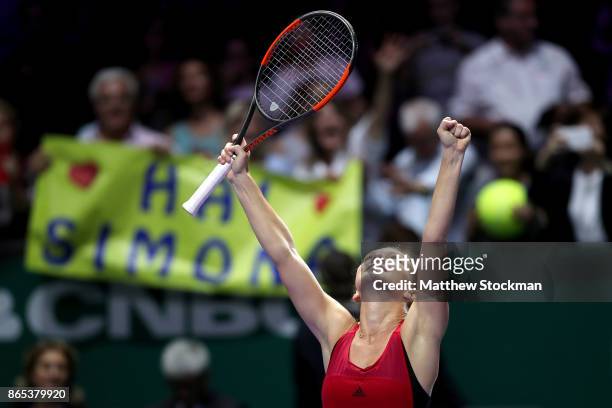 Simona Halep of Romania celebrates victory in her singles match against Caroline Garcia of France during day 2 of the BNP Paribas WTA Finals...