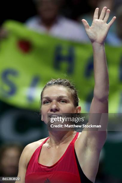 Simona Halep of Romania celebrates victory in her singles match against Caroline Garcia of France during day 2 of the BNP Paribas WTA Finals...