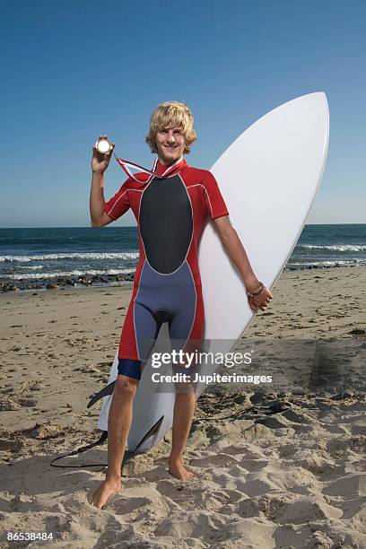 teenage boy on beach with surfboard - surfer stock pictures, royalty-free photos & images