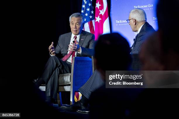 Lee Hsien Loong, Singapore's prime minister, speaks as David Rubenstein, co-chief executive officer of Carlyle Group LP, right, listens during an...