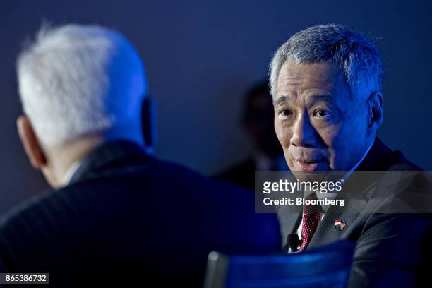 Lee Hsien Loong, Singapore's prime minister, speaks as David Rubenstein, co-chief executive officer of Carlyle Group LP, left, listens during an...