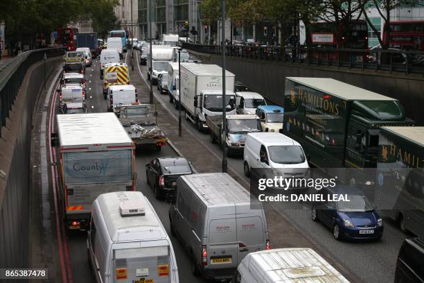 Vehicles wait in a traffic jam in central London, England on October 23, 2017. - Drivers of the most polluting vehicles will face an extra daily...