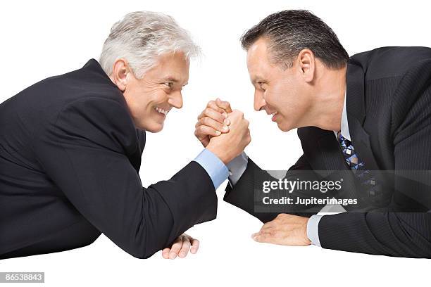 businessmen arm wrestling - arm wrestle stock pictures, royalty-free photos & images