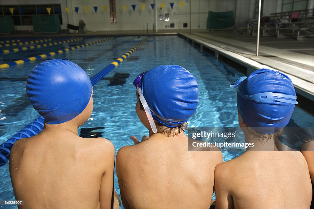 Swimmers sitting poolside