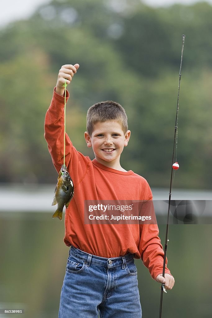 Portrait Of Boy With Fishing Pole And Fish High-Res Stock Photo - Getty  Images