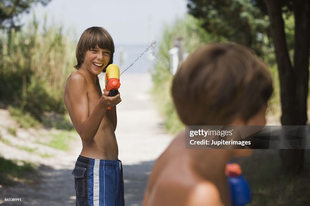 Boy playing with water gun