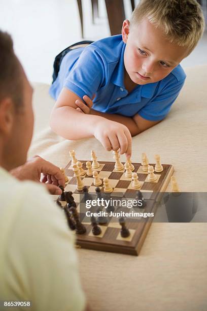 Premium Photo  Twin brothers playing chess isolated on white