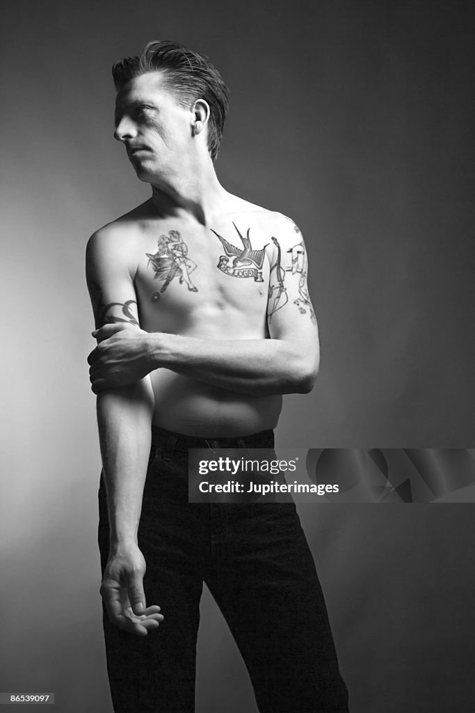 Man posing with tattoos