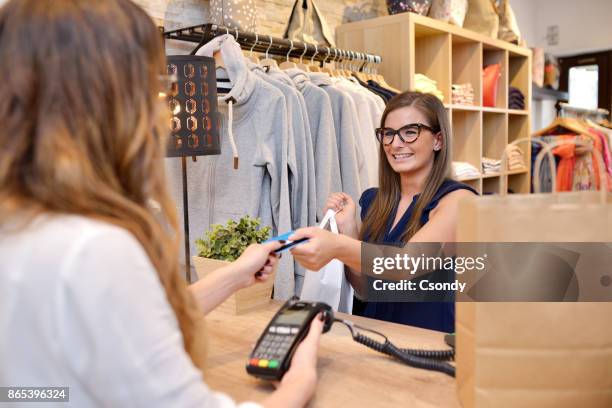 customer paying with credit card - clothes shop counter stock pictures, royalty-free photos & images