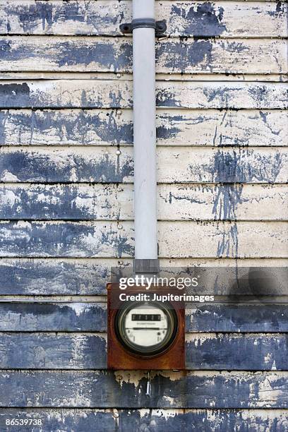 electric meter on weathered urban wall - electric-meter stock pictures, royalty-free photos & images
