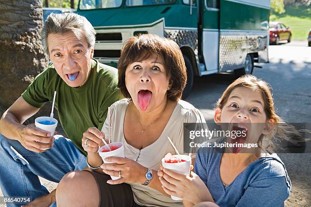 grandparents and girl eating icy treat - snow cones shaved ice stock pictures, royalty-free photos & images