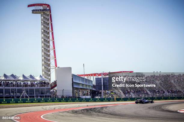 Driver exits turn 14 with COTA tower and fans in crowd in background during the Formula 1 United States Grand Prix on October 22 at the Circuit of...
