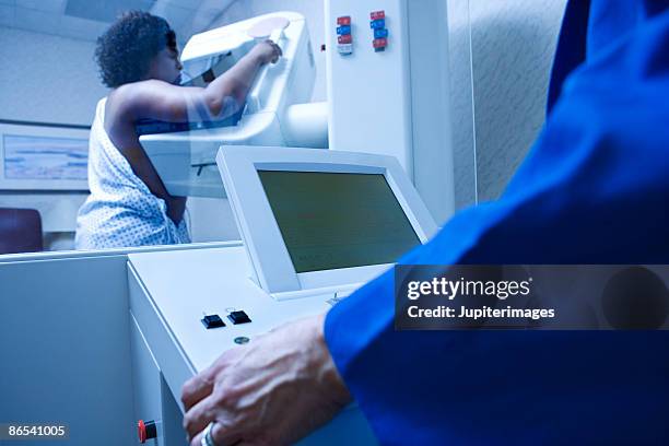 woman getting mammogram - mammogram stock pictures, royalty-free photos & images