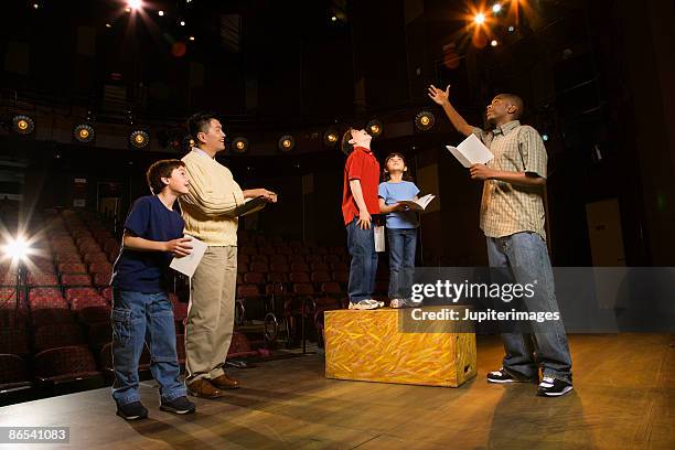 teacher and students practicing a play - student on stage stock pictures, royalty-free photos & images