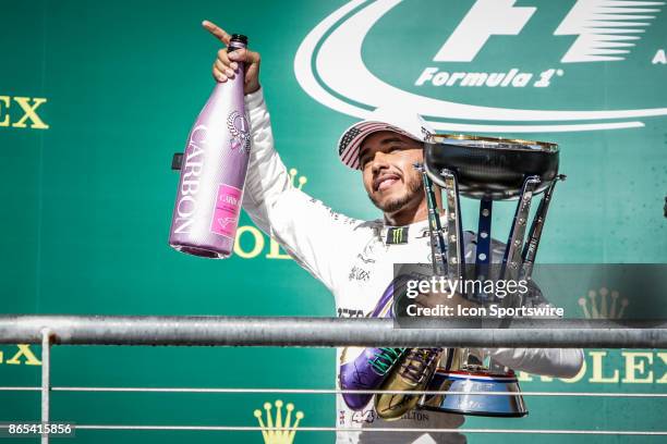 Mercedes driver Lewis Hamilton of Great Britain acknowledges crowd after winning the Formula 1 United States Grand Prix on October 22 at the Circuit...