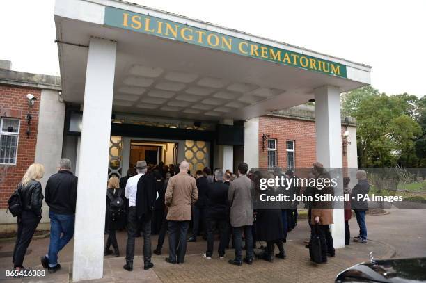 The congregation outside the chapel at the funeral of comedian Sean Hughes at Islington and Camden Cemetery in London.