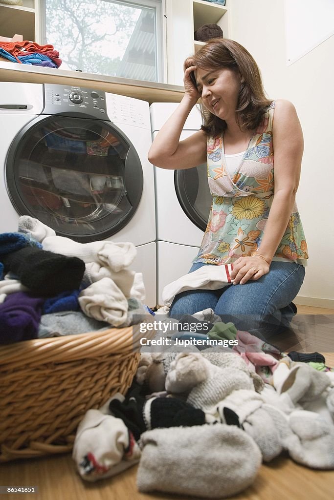 Stressed woman in laundry room
