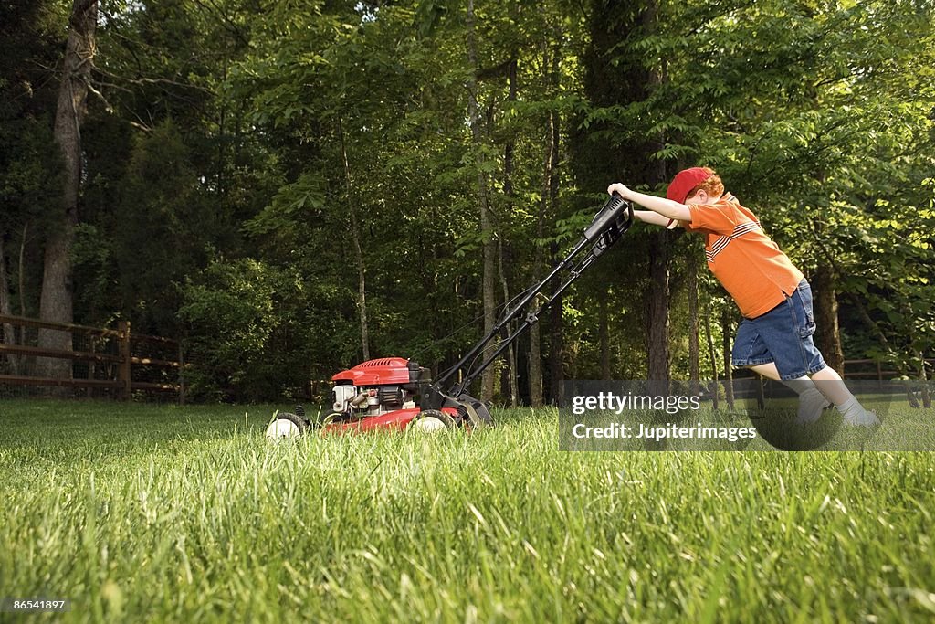 Boy mowing lawn