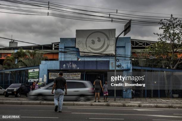 Pedestrians pass in front of a closed government-run restaurant, Restaurante Popular, near the Favela do Lixo in Rio de Janeiro, Brazil, on Thursday,...