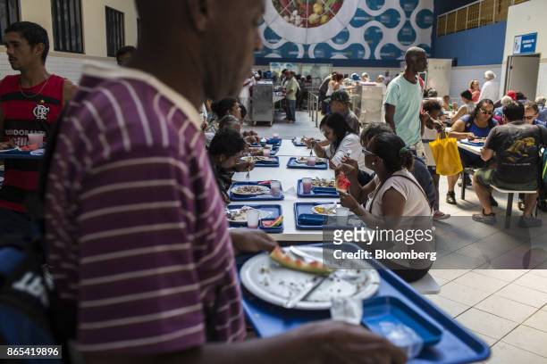 Residents eat at a government-run restaurant, Restaurante Popular, in the Bangu neighborhood of Rio de Janeiro, Brazil, on Friday, Aug. 25, 2017....