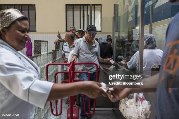 Residents stand on line to enter a government-run restaurant, Restaurante Popular, in the Bangu neighborhood of Rio de Janeiro, Brazil, on Friday,...