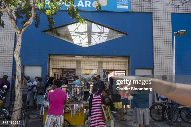 Residents stand on line to enter a government-run restaurant, Restaurante Popular, in the Bangu neighborhood of Rio de Janeiro, Brazil, on Friday,...