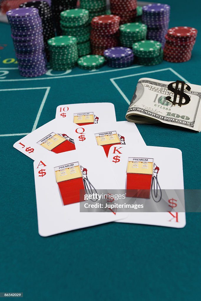 Gas pump playing cards with money and poker chips