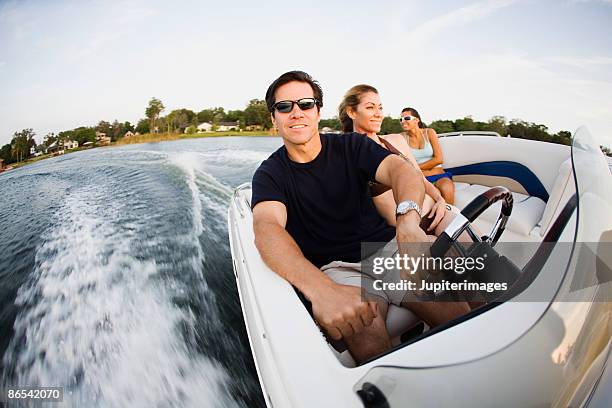 friends riding speedboat - steering boat stock pictures, royalty-free photos & images