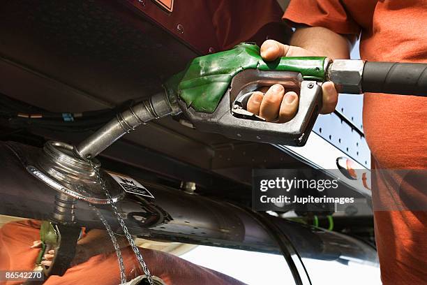 trucker pumping gas - gas truck ストックフォトと画像