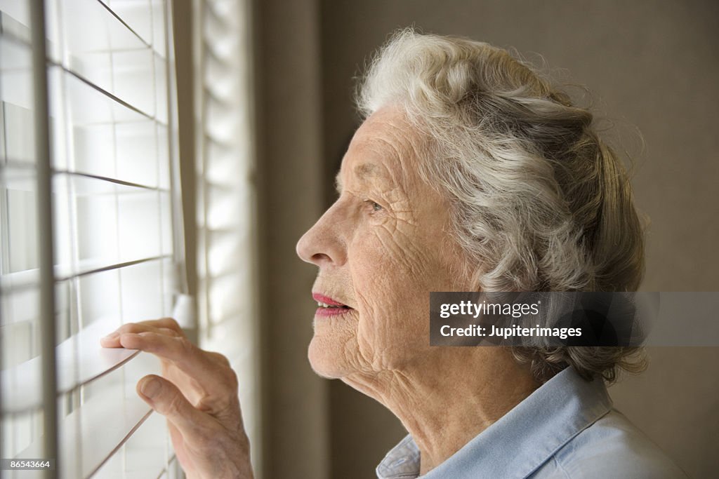 Woman looking out window