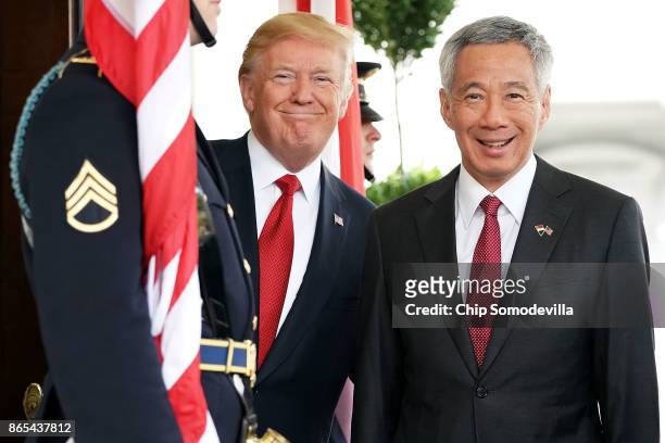 President Donald Trump and Singapore Prime Minister Lee Hsien Loong pose for photographers outside the White House West Wing October 23, 2017 in...
