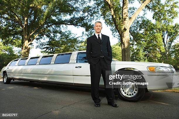 limousine chauffeur standing in suit - limo driver stock pictures, royalty-free photos & images