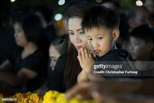 People gather to pay their respects to Thailand's late King Bhumibol Adulyadej, for the last time before the roads around the Royal Palace are closed...