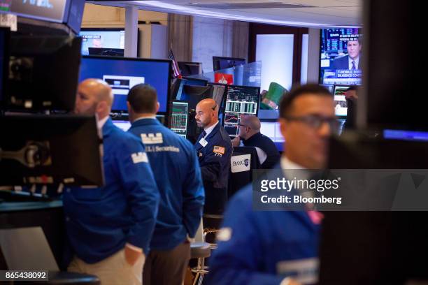 Traders work on the floor of the New York Stock Exchange in New York, U.S., on Monday, Oct. 23, 2017. U.S. Stocks got off to a slow start as...