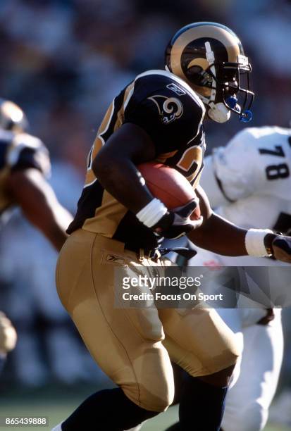 Marshall Faulk of the St. Louis Rams carries the ball against the Philadelphia Eagles during an NFL football game September 9, 2001 at Veterans...