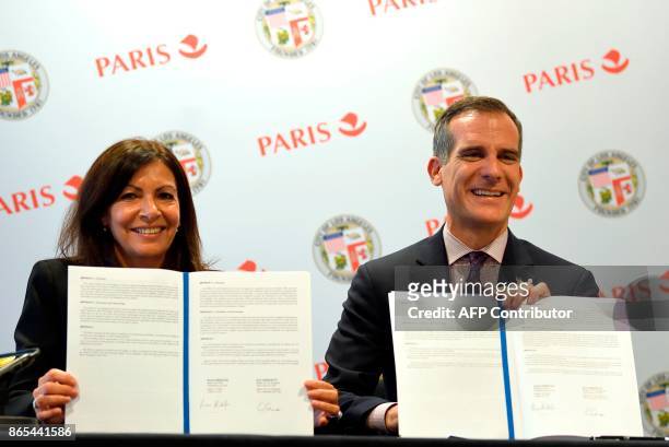 Paris mayor Anne Hidalgo and Los Angeles mayor Eric Garcetti pose after signing an Olympic twinning cooperation agreement ahead of the 2024 and 2028...