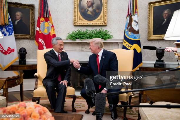 President Donald Trump welcomes Prime Minister Lee Hsien Loong of Singapore to the Oval Office before a series of meetings between the two at the...
