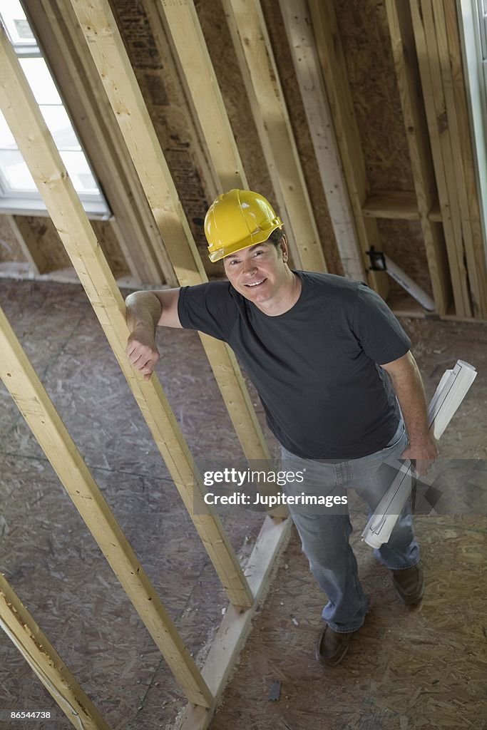 Construction worker with blueprints