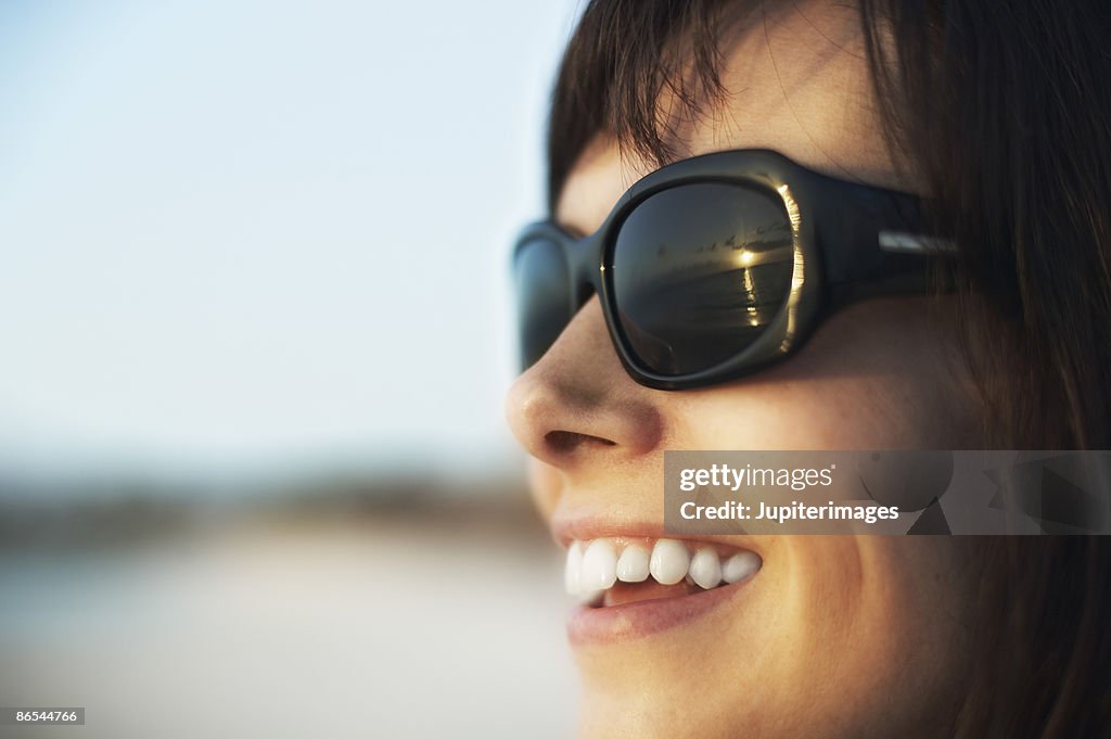 Smiling woman wearing sunglasses