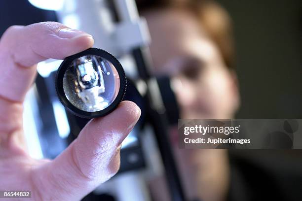 ophthalmologist adjusting slit lamp - slit lamp stock pictures, royalty-free photos & images