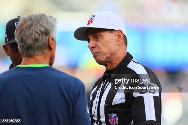 Referee Tony Corrente talks with Seattle Seahawks head coach Pete Carroll on the field prior to the National Football League game between the New...