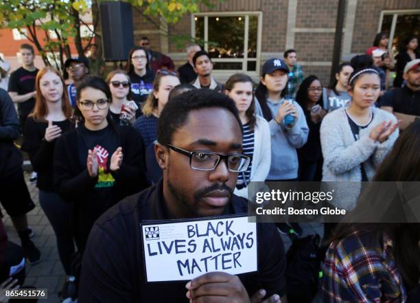 Boston College graduate student John Gabelus listens during the rally at Boston College in Newton, MA on Oct. 20, 2017. The event was held to protest...