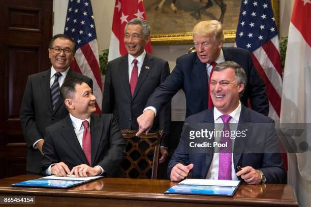 Boeing Executive Vice President Kevin McAllister and CEO of Singapore Airlines Goh Choon Phong along US President Donald Trump and Lee Hsien Loong of...