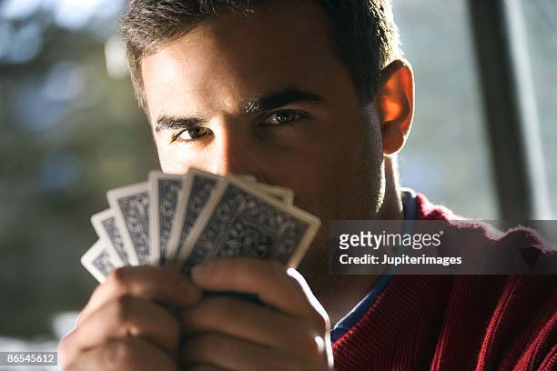 man playing cards - thinking of you card stock-fotos und bilder