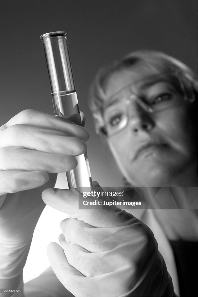 Doctor with test tube of liquid