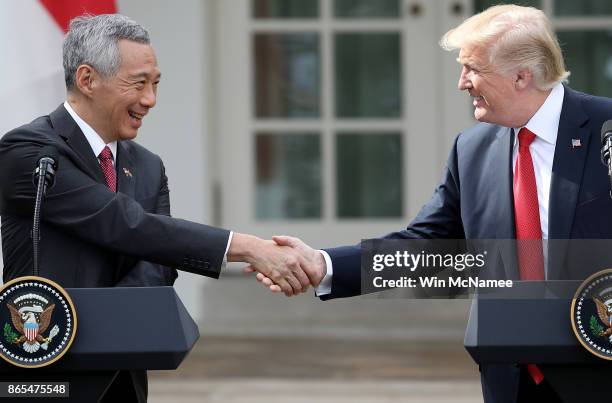 President Donald Trump and Singapore Prime Minister Lee Hsien Loong shake hands while delivering joint statements in the Rose Garden of the White...