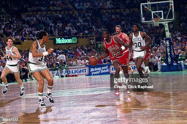 Michael Jordan of the Chicago Bulls moves the ball up court against Dennis Johnson of the Boston Celtics in Game One of the Eastern Conference...