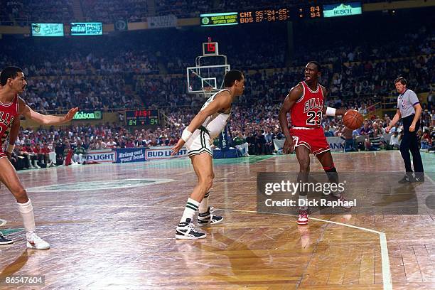 Michael Jordan of the Chicago Bulls moves the ball up court against Dennis Johnson of the Boston Celtics in Game One of the Eastern Conference...